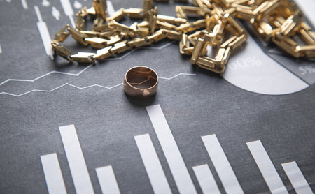 Golden jewelry on financial graphs.の写真素材