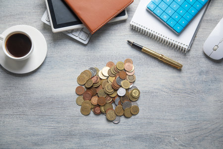 Stack of coins on the desk with a business objects.の写真素材