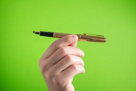 Male hand with a pen writes in empty screen.の写真素材