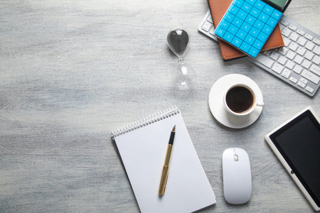 Notepad, pen, with a different business objects on the table.