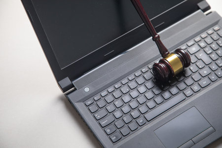 Black laptop computer with a judge gavel.の写真素材