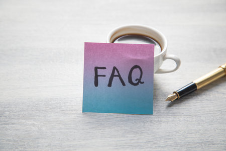 Faq message written on sticky note.の写真素材