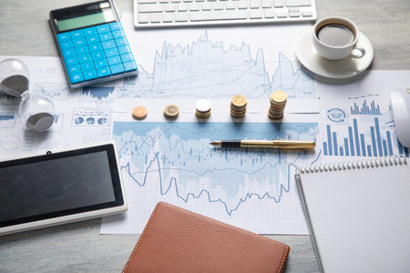 Stack of coins with a financial growth graphs.の写真素材