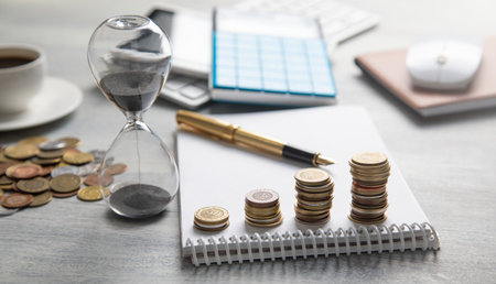 Stack of coins on the desk with a business objects.の写真素材
