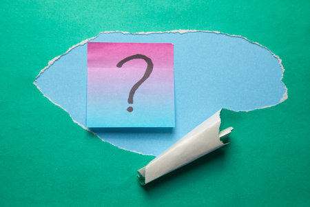 Torn paper with a question mark.の写真素材