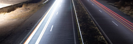 Highway car light trails at night.