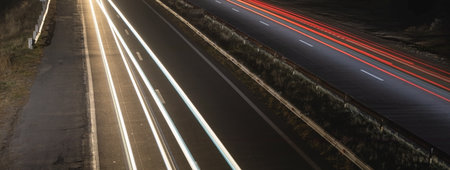 Highway car light trails at night.