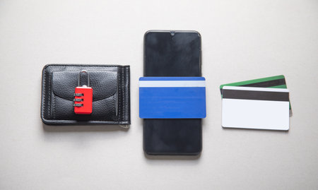 Smartphone, wallet, credit cards with a padlock.