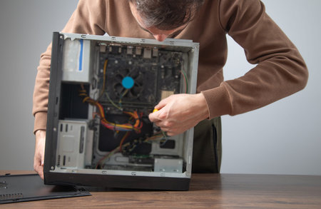Caucasian master repairing computer. Computer maintenanceの写真素材