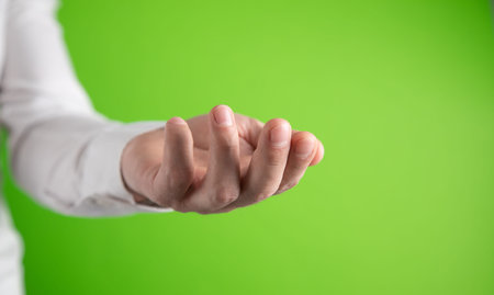 Young caucasian man showing empty hand.の写真素材