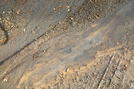 Dirty and muddy ground road in the nature at spring time.の写真素材