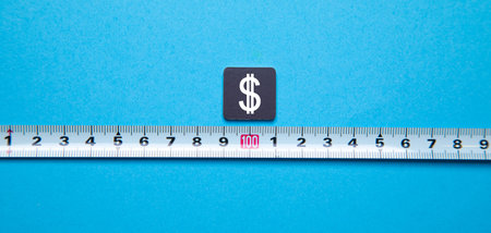 Dollar symbol on a tape measure on a blue background. Business concept