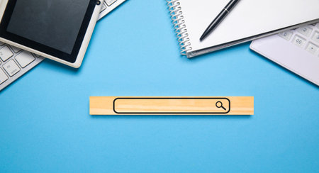 Top view of wooden progress bar on blue background with laptop, tablet and calculator