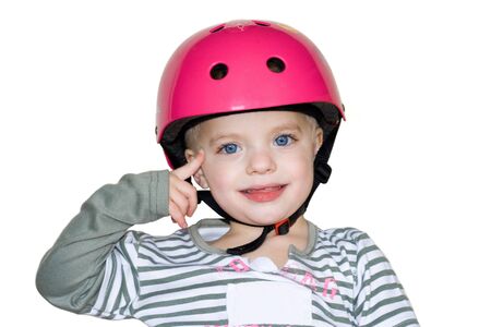 Small blone girl wearing a red helmet points to her temple showing her great idea. Isolated on whiteの写真素材