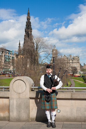 Edinburgh, UK - APRIL 25, 2013  Scottish Bagpiper playing music with bagpipe at Edinburgh in Scotland のeditorial素材