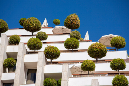 Eilat, Israel - February 11, 2016: Detail of a eco-friendly building with trees on the balkons in Eilat, Israelのeditorial素材