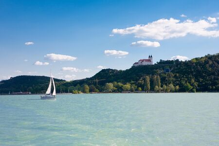 Tihany Abbey  and a sailboat from Lake Balaton in Hungaryの写真素材