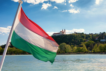 Tihany Abbey viewed from a ship with the Hungarian flag in the front at Lake Balaton, Hungaryの写真素材