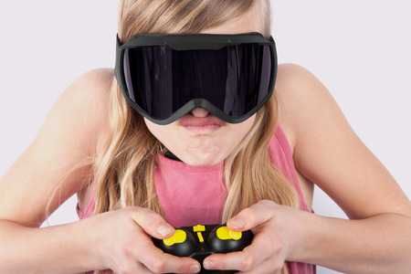Girl playing VR game using virtual reality glasses and a controller