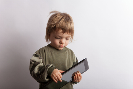 Baby boy with a tablet pc deviceの写真素材