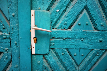 Vintage blue painted wooden door with door handle detailの写真素材