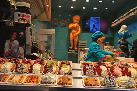 BRUSSELS, BELGIUM - 20 FEBRUARY, 2017 Inside a belgian waffle store, many delicious plates lined up with different toppings such as chocolate, cream, berriesのeditorial素材