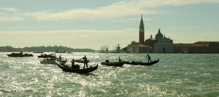 Venice cityscape view on Santa Maria della Salute basilica with gondolas on the Grand canalの写真素材