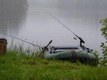 Inflatable boat with fishing rods on the lakeの写真素材