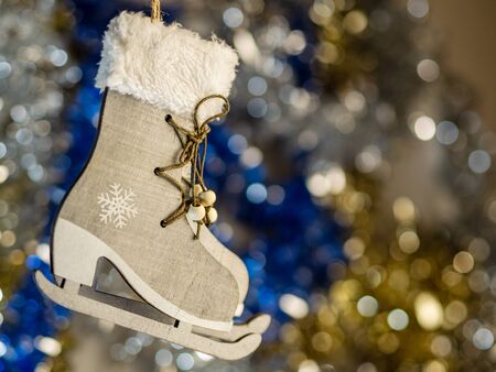 Christmas skates on a background of lights and bright beautiful  tinsel. Christmas design card with place for text. Xmas decorations. Good New Year spirit.の写真素材
