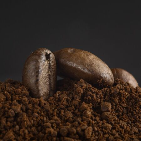 Brown roasted coffee beans, seed on dark background. Espresso dark, aroma, black caffeine drink. Closeup energy mocha, cappuccino ingredient.の写真素材