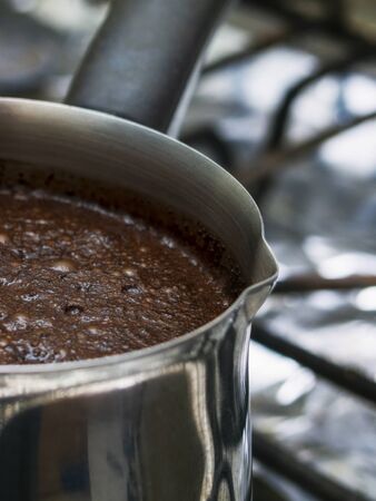 ground coffee is brewed in a steel Turk.の写真素材