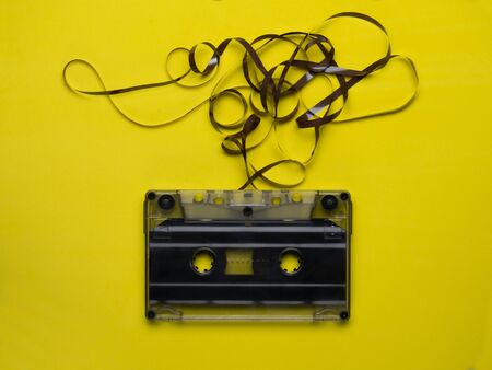 Retro cassette tape over yellow wooden table. top view. copy space.の写真素材