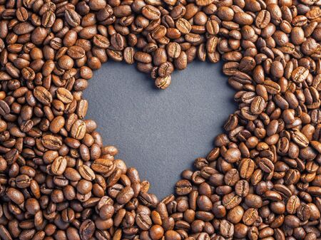 Heart coffee frame made of coffee beans on burlap texture.の写真素材
