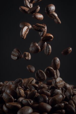 falling coffee beans on the dark background.の写真素材
