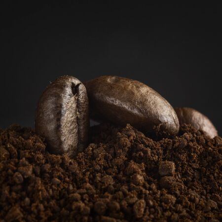 Brown roasted coffee beans, seed on dark background. Espresso dark, aroma, black caffeine drink. Closeup energy mocha, cappuccino ingredient.の写真素材