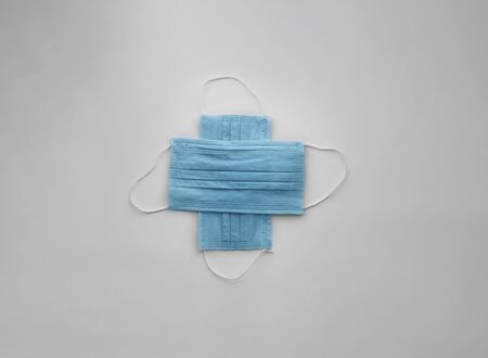 medical protective masks cross shape on white with copy space