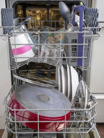 Open dishwasher with clean dishesの写真素材