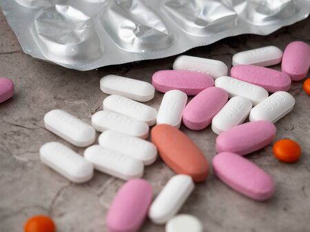 multicolored medical pills and packs of pills on a table.の写真素材