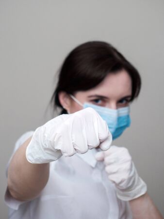 women in medical gloves box, home quarantine, coronavirus pandemic, on a white background, the fight against the virusの写真素材