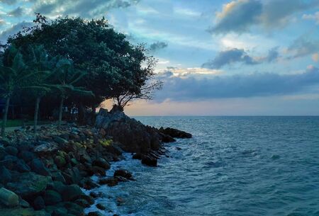 Deserted beach in blue clear sea and green trees.の写真素材
