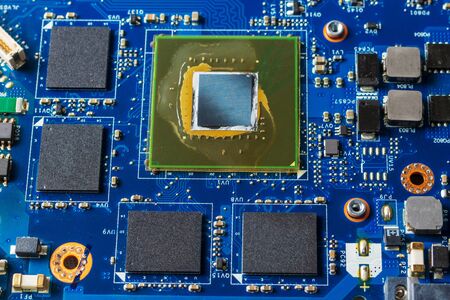 Close up of a printed blue computer circuit boardの写真素材