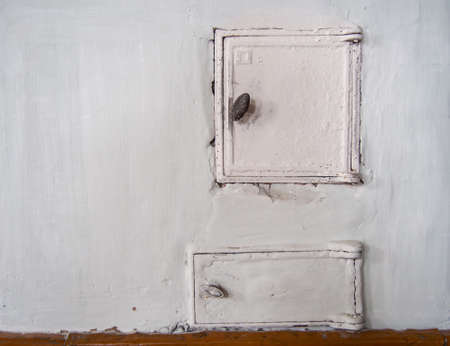 door of an old stove in a Russian village houseの写真素材
