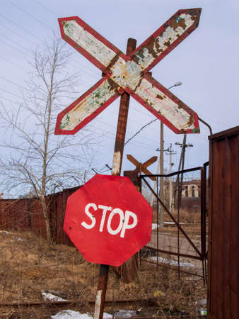 Old and rusty railroad sign with stop letters.の写真素材