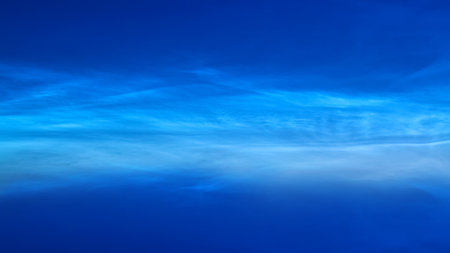White Spindrift clouds on blue skyの写真素材
