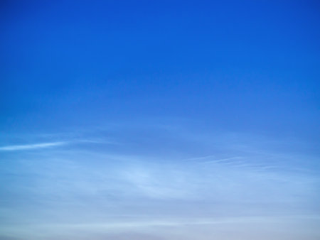 White Spindrift clouds on blue skyの写真素材