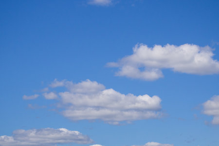 white fluffy clouds in the blue skyの写真素材
