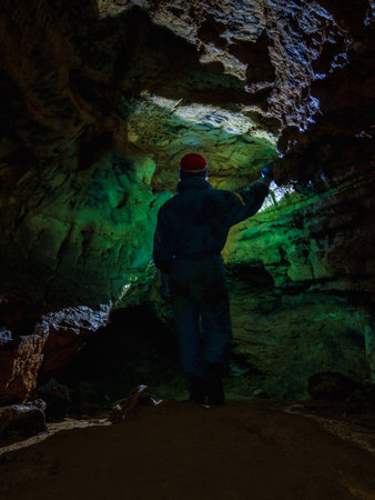 Young girl caver exploring in the caveの写真素材