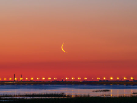 Sunset or sunrise with clouds. Red sunset and moon. beautiful sky. Prayer time. Generous Ramadan. Mubarak background.の写真素材