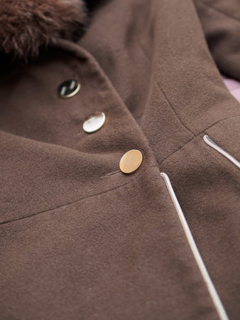 Close up of fashionable mens brown coat combined with brown fashionable sweater. Low DOF.の写真素材