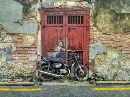 PENANG, MALAYSIA-2018-01-05: General view of a mural 'Boy on a Bike' painted by Ernest Zacharevic in Penang on July 6, 2013. The mural is one of the 9 murals paintings in early 2012のeditorial素材